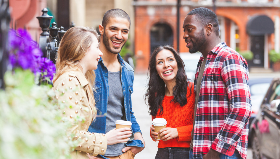4 people speaking outside a residential building.